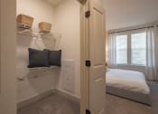 Thumbnail 29 of 40 - a bedroom with a bed and a white closet