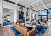 Thumbnail 6 of 78 - a living room with couches and chairs and a table at Altis Blue Lake, Lake Worth, 33467