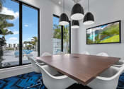 Thumbnail 11 of 78 - a dining room with a large window and a table with chairs at Altis Blue Lake, Lake Worth, Florida