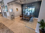 Thumbnail 31 of 49 - A glass door separates a living room from a dining room.