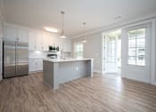 Thumbnail 57 of 67 - a kitchen with white cabinets and a large island