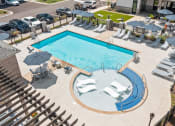 Thumbnail 13 of 60 - a swimming pool with chairs and umbrellas next to a hotel pool