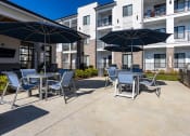 Thumbnail 16 of 60 - our patio with tables and chairs and umbrellas at our apartments on the strip