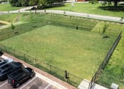 Thumbnail 19 of 60 - a parking lot with cars parked next to a grass field