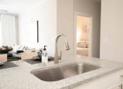 Thumbnail 22 of 60 - a kitchen sink with a view of a living room