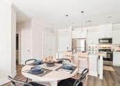 Thumbnail 23 of 60 - a kitchen and dining room with a table and chairs