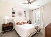 Thumbnail 27 of 60 - a bedroom with a bed and a ceiling fan