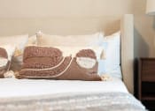 Thumbnail 28 of 60 - a bed with a pile of pillows on top of it