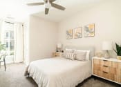 Thumbnail 31 of 60 - a bedroom with a bed and a ceiling fan