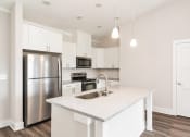 Thumbnail 36 of 60 - a kitchen with white cabinets and a stainless steel refrigerator