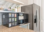 Thumbnail 3 of 60 - a kitchen with a refrigerator and a coffee machine