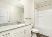 Thumbnail 42 of 60 - a bathroom with a sink and a shower and a mirror