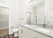 Thumbnail 43 of 60 - a bathroom with a mirror and a toilet and a sink