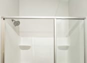 Thumbnail 44 of 60 - a bathroom with a shower with a glass door