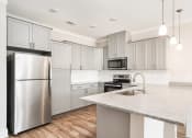 Thumbnail 49 of 60 - a kitchen with stainless steel appliances and a marble counter top