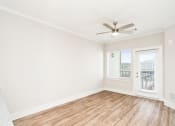 Thumbnail 51 of 60 - an empty living room with a ceiling fan and a window