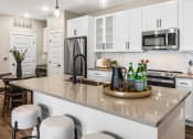 Thumbnail 66 of 94 - an open kitchen with a large counter with a center island