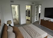 Thumbnail 18 of 36 - A bedroom with a large bed and a flat screen TV.
