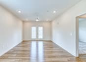 Thumbnail 35 of 40 - an empty living room with white walls and wood floors