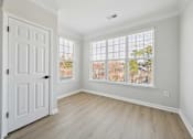 Thumbnail 54 of 59 - A room with a white door and a window with blinds.