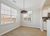 Thumbnail 51 of 59 - A room with a large window and a hanging light fixture.