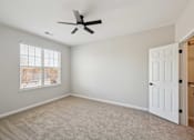 Thumbnail 55 of 59 - A room with a ceiling fan and a window with blinds.