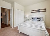 Thumbnail 17 of 42 - A bedroom with a large bed and a pair of skis on the wall.