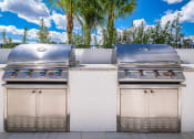 Thumbnail 44 of 78 - two stainless steel bbqs on a patio with trees at Altis Blue Lake, Lake Worth, FL, 33467