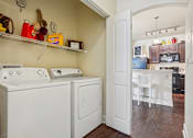 Thumbnail 24 of 42 - A laundry room with a washer and dryer.