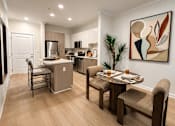 Thumbnail 3 of 41 - A modern kitchen with a dining table set for two.