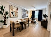 Thumbnail 5 of 41 - A living room with a dining table and chairs.