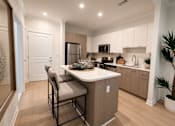 Thumbnail 1 of 41 - A kitchen with a table and chairs in the middle of the room.