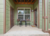 Thumbnail 19 of 42 - A small patio with a table and chairs.