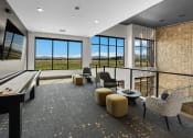 Thumbnail 14 of 94 - a living room with a view of a field and a table and chairs