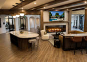 Thumbnail 10 of 40 - A modern living room with a fireplace and a television.
