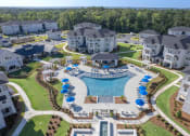Thumbnail 1 of 54 - an aerial view of a large swimming pool in an apartment complex