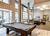 Thumbnail 9 of 26 - a pool table is in the center of a living room