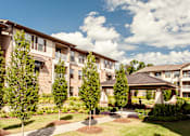 Thumbnail 13 of 18 - Apartment complex with a gazebo in the front yard.