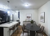 Thumbnail 9 of 36 - A modern dining room with a round table and chairs.