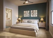 Thumbnail 6 of 7 - Three-Bedroom Luxury Apartments in Bradenton, FL - Eventide Apartments - Bedroom With Wood-Grain Plank Flooring, Large Bed, Ceiling Fan, Matching Nightstands, Private Bathroom, and Large Window.