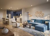 Thumbnail 5 of 7 - Bradenton, FL, Pet-Friendly Luxury Apartments - Eventide Apartments - Living Room With Wood-Grain Plank Flooring, Blue Sectional Sofa, Armchair, Coffee Table, and Recessed Lighting.