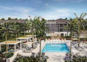 Thumbnail 2 of 7 - Bradenton, FL, Luxury Apartments with In-Unit Washer and Dryer - Eventide Apartments - Swimming Pool With Lounge Chairs, Shaded Cabanas, Palm Trees, and Colorful Landscaping.