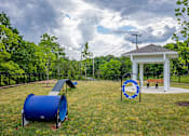 Thumbnail 28 of 31 - A playground with a blue barrel and a gazebo.