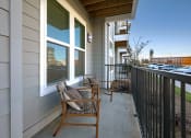 Thumbnail 33 of 40 - a view of a balcony with tables and chairs and a building in the background