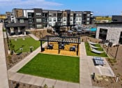 Thumbnail 53 of 94 - an aerial view of an apartment complex with a picnic area and lawn