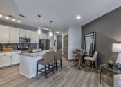 Thumbnail 10 of 25 - an open kitchen and living room with a dining room table and chairs