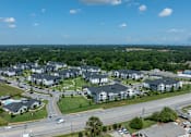 Thumbnail 49 of 49 - A large residential complex with multiple buildings and a parking lot.
