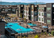 Thumbnail 60 of 94 - an aerial view of a swimming pool at an apartment complex