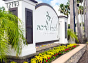 Thumbnail 31 of 31 - A white building with a sign that says North Beach on it.