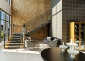 Thumbnail 13 of 94 - a lobby with a staircase and a table and chairs